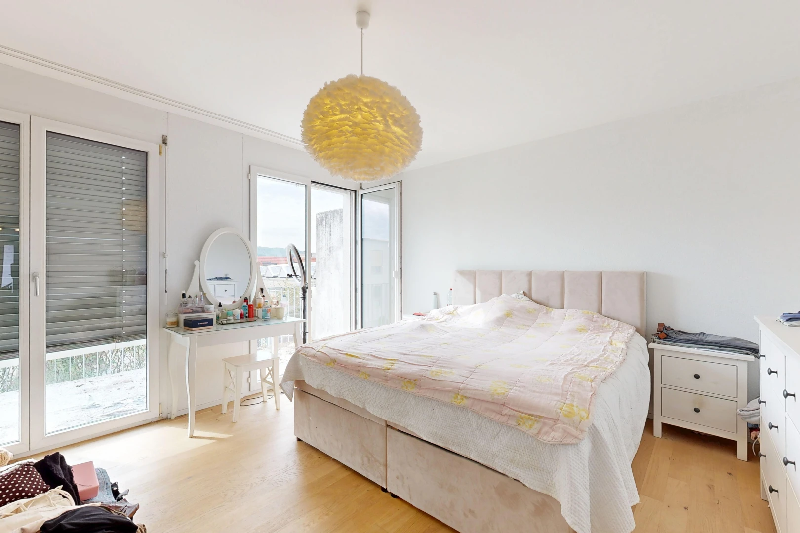 room featuring decorative light fixtures, access to exterior, and light wood-type flooring