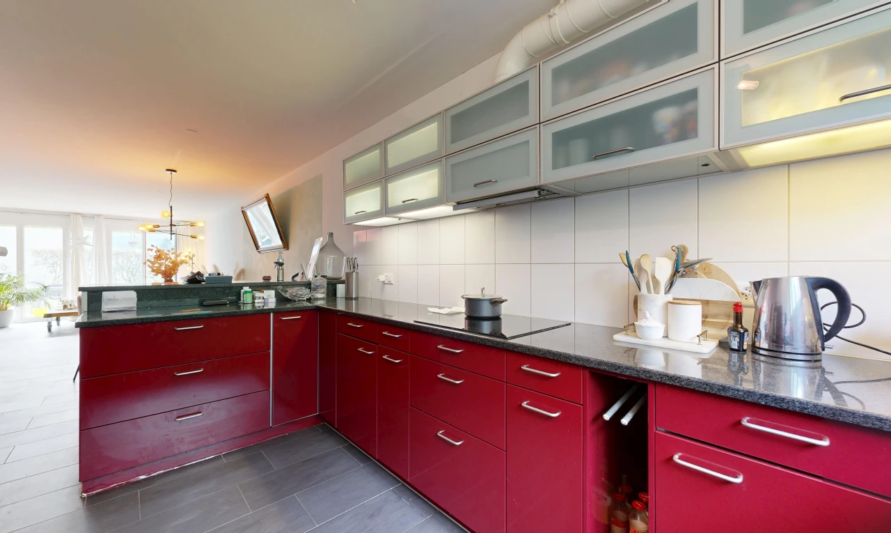 kitchen featuring glass insert cabinets, black electric cooktop, dark stone countertops, and tasteful backsplash