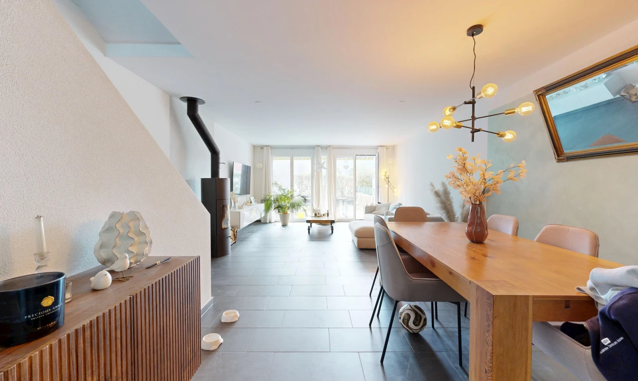 living / dining area with a wood stove and access to exterior