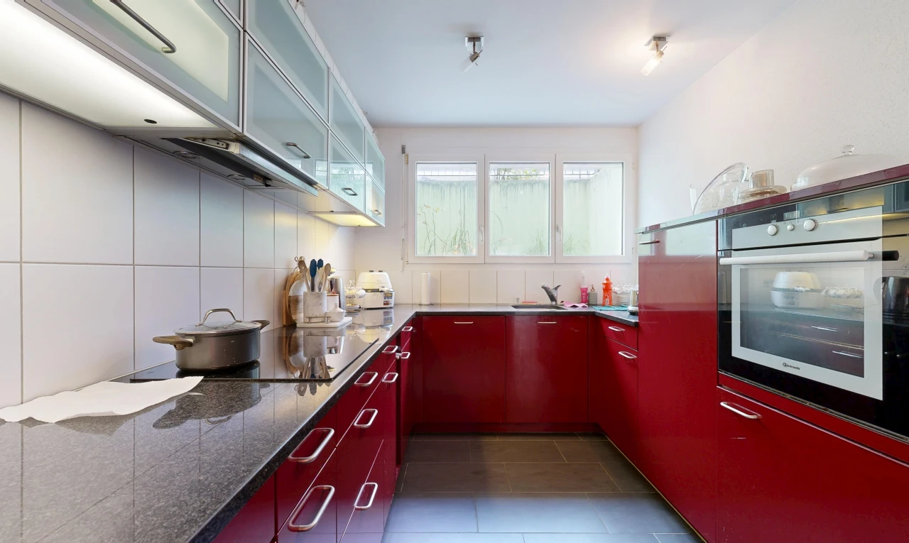 kitchen with stainless steel oven, glass fronted cabinets, dark tile patterned flooring, and black electric stovetop