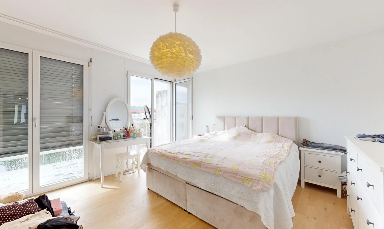 room featuring decorative light fixtures, access to exterior, and light wood-type flooring