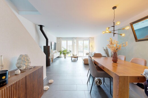 living / dining area with a wood stove and access to exterior