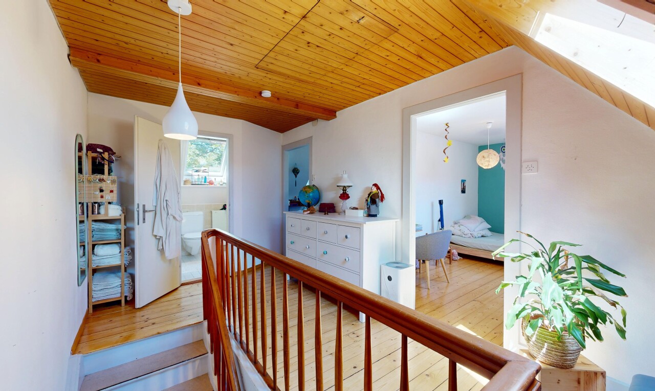 upstairs landing featuring pendant lighting, a wood ceiling with exposed beams, and wood-type flooring