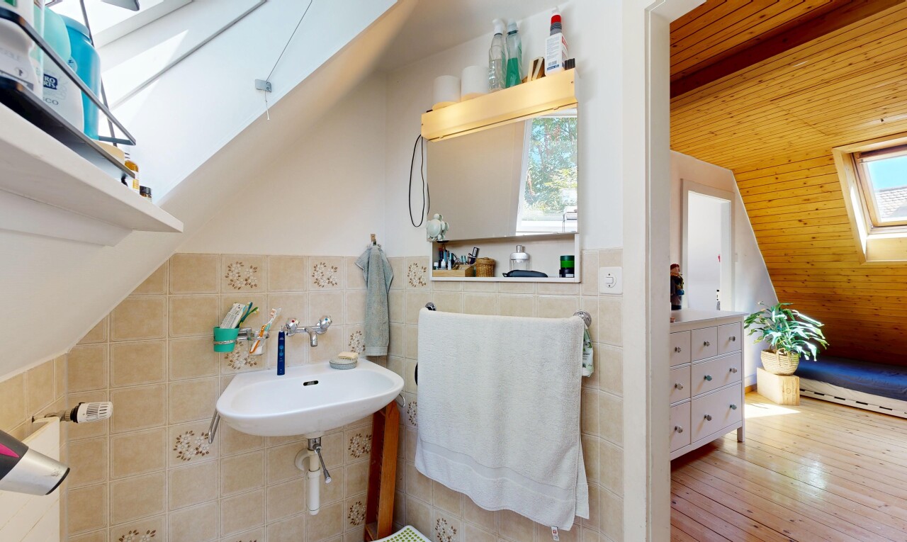 bathroom featuring tile walls, wood ceiling, vaulted ceiling with skylight, and light wood-style flooring