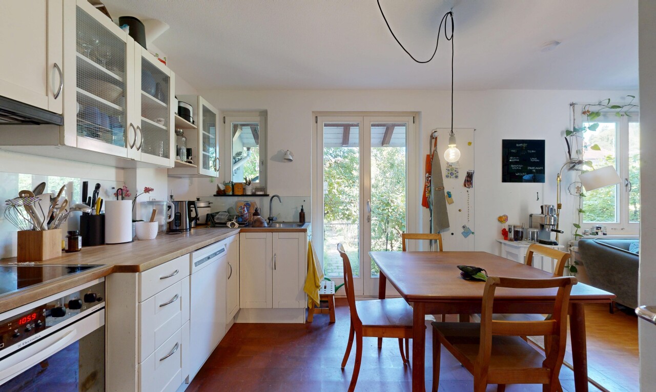kitchen with white appliances, white cabinetry, and glass insert cabinets