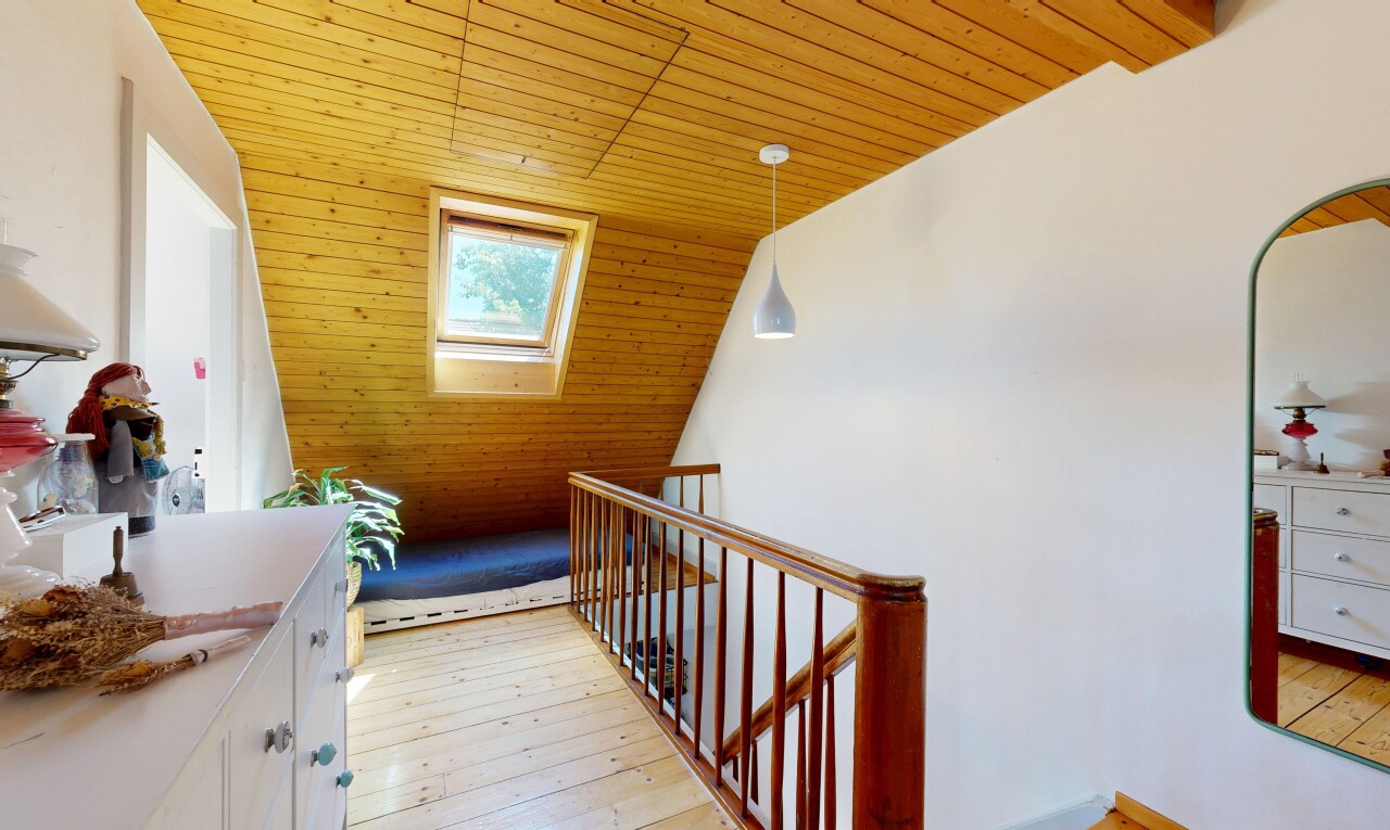 hallway with a vaulted wood ceiling, pendant lighting, light wood-type flooring, and an upstairs landing