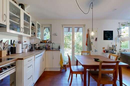 kitchen with white appliances, white cabinetry, and glass insert cabinets
