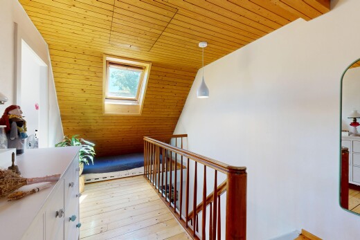hallway with a vaulted wood ceiling, pendant lighting, light wood-type flooring, and an upstairs landing