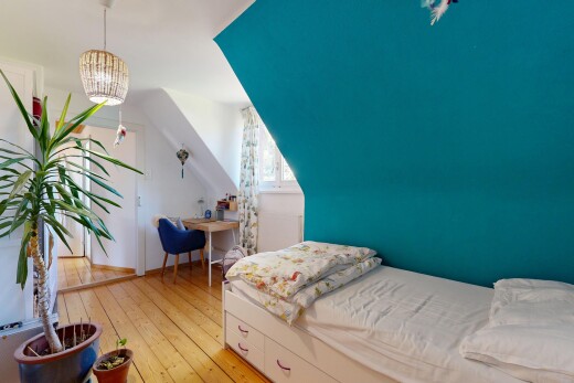 room with a desk, light wood finished floors, and pendant lighting