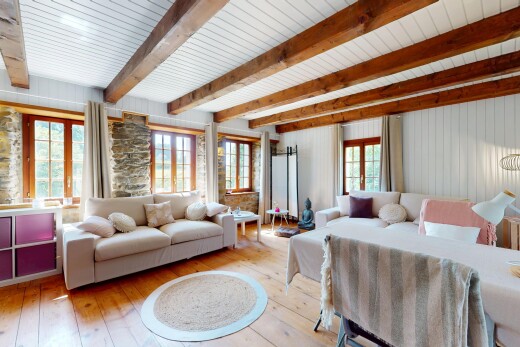 living room with hardwood / wood-style flooring and beam ceiling