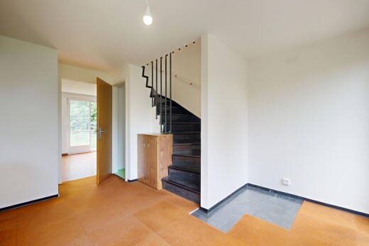 unfurnished room with stairway and baseboards