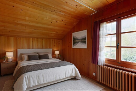 carpeted room featuring radiator, wood walls, and a vaulted wood ceiling