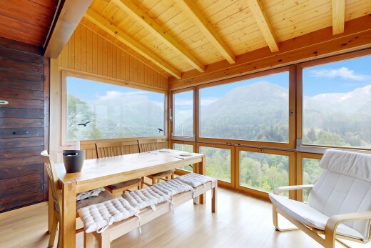dining space featuring wood ceiling, vaulted ceiling with beams, light wood-style flooring, and wooden walls