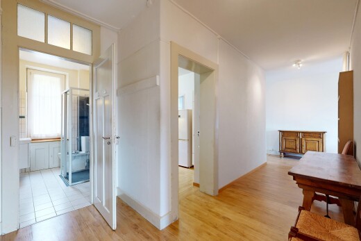 couloir avec wood finish floor, sol en finition bois, light floor, drywall, et cloison sèche