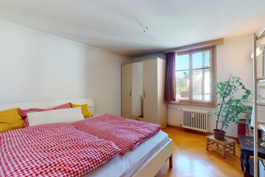 chambre à coucher avec parquet, lumière naturelle, et radiateur