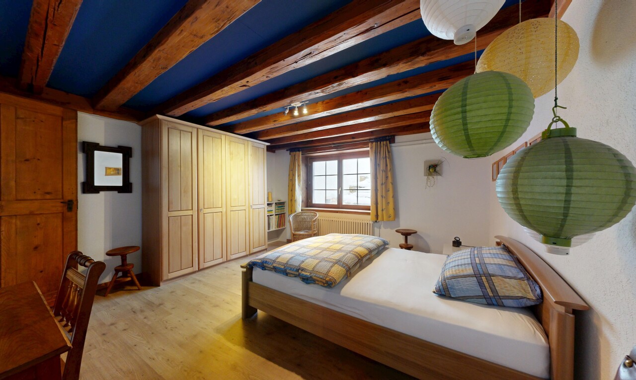 chambre avec inside property, sol en finition bois, wood finish floor, plafond à poutres, et beamed ceiling