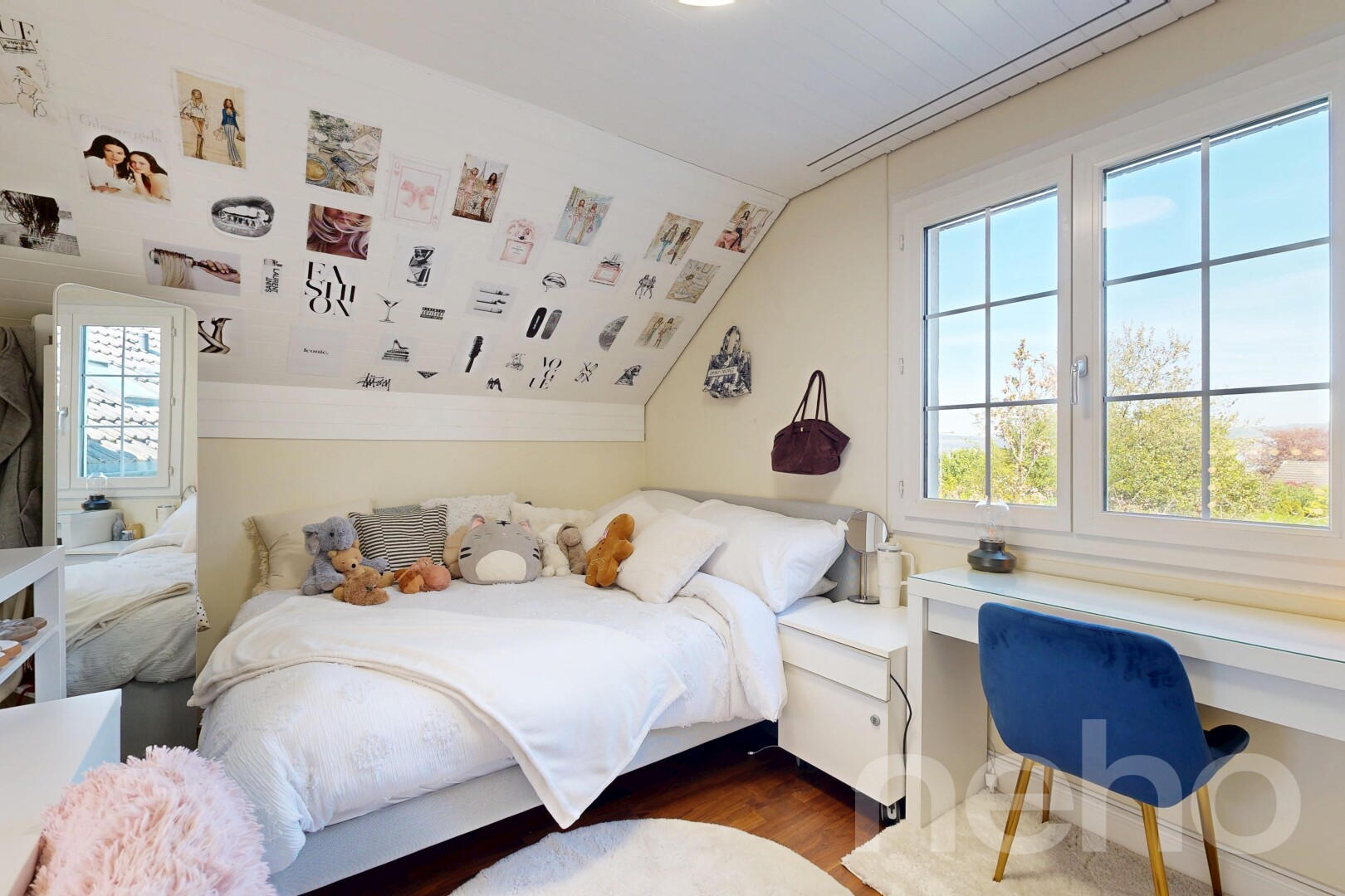 room featuring multiple windows, wood finished floors, lofted ceiling, and a desk