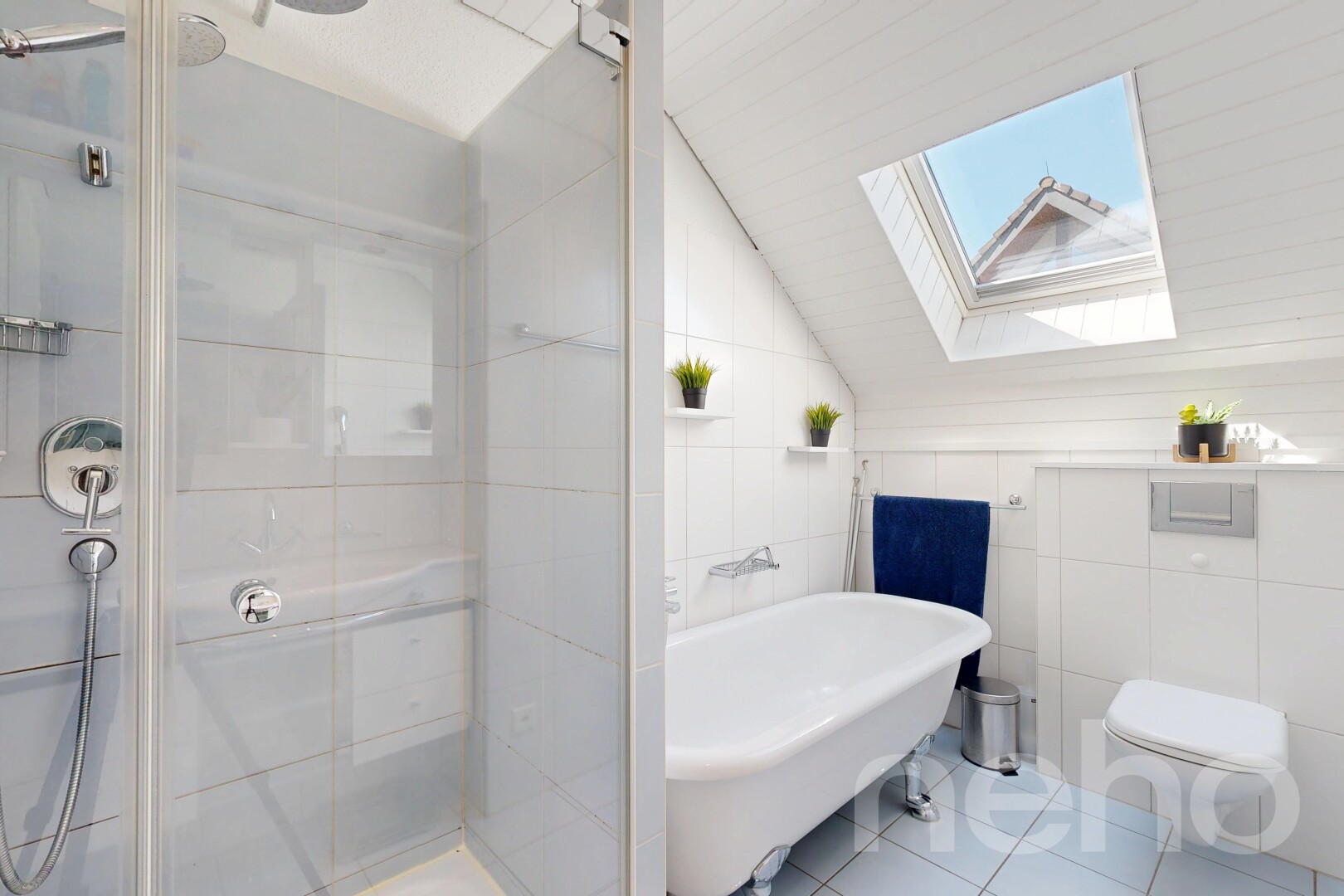 full bathroom featuring a skylight, lofted ceiling, tile walls, a shower stall, and light tile patterned floors