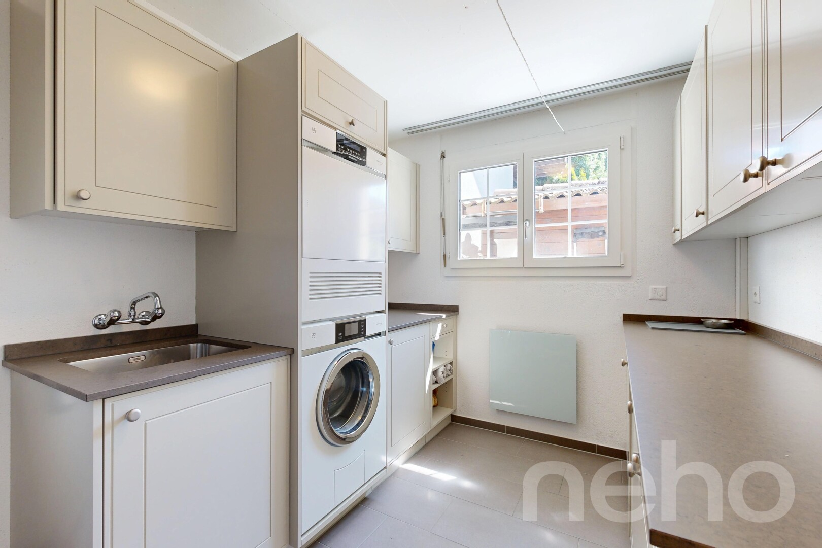 laundry area with cabinet space and baseboards