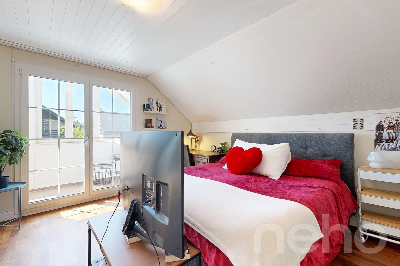 room with wood finished floors and lofted ceiling