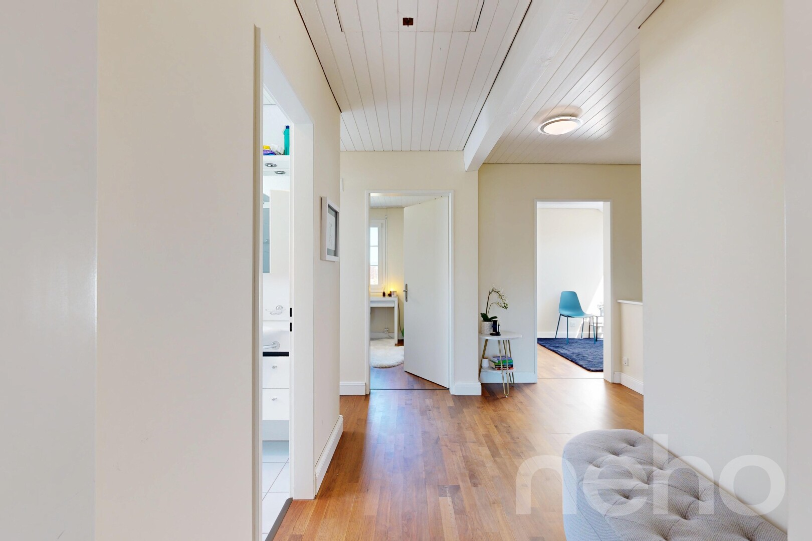 corridor with light wood-style floors and wooden ceiling