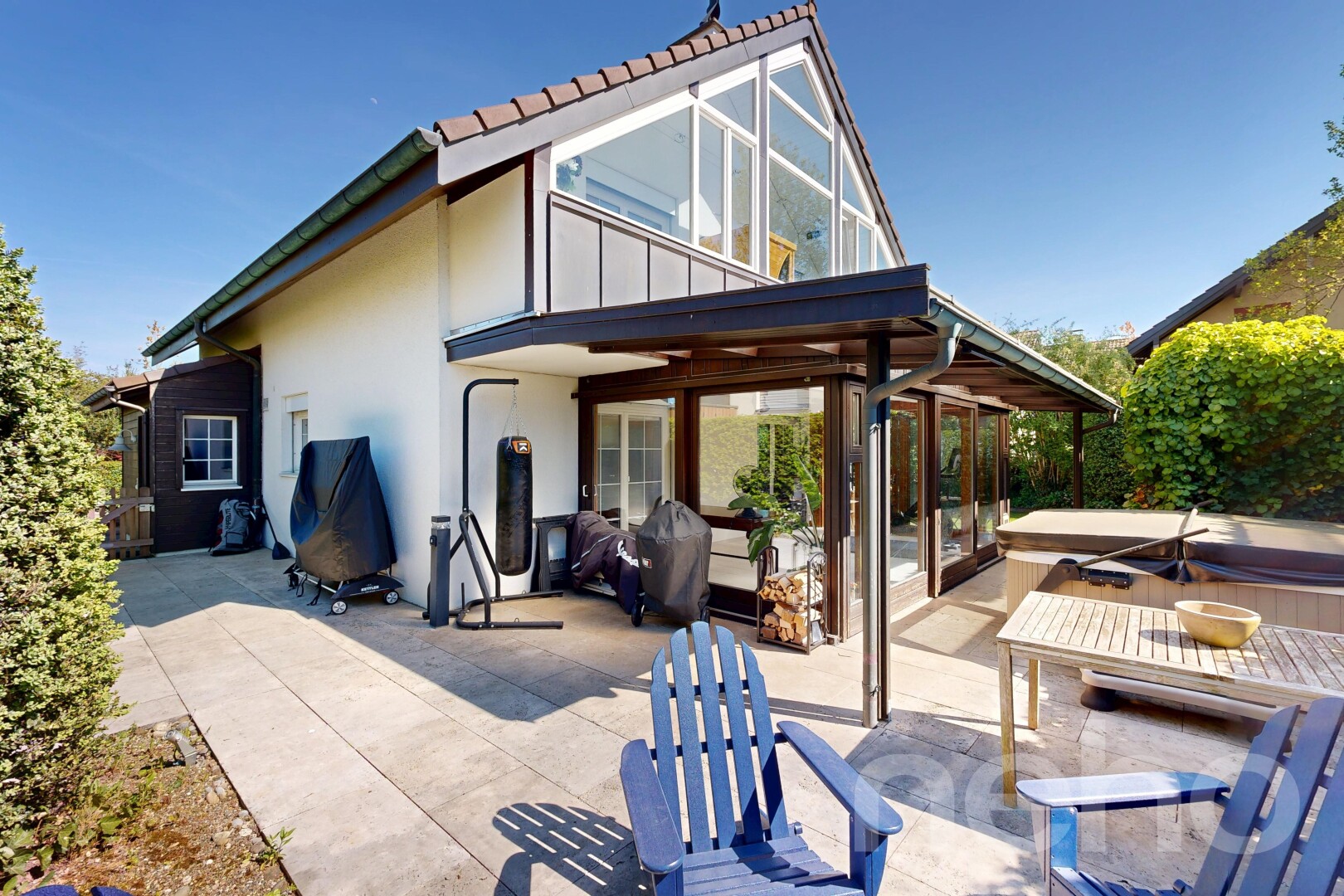 terrace featuring a patio, a hot tub, and a grill