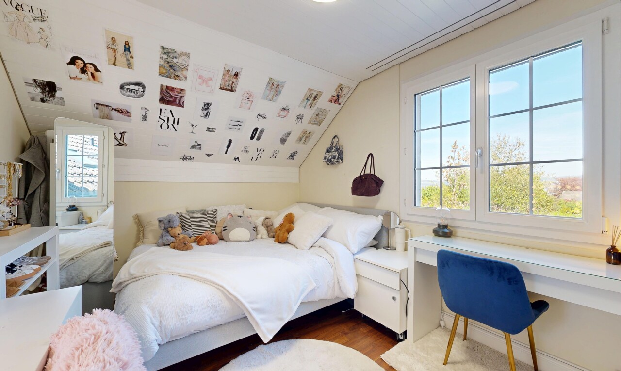 room featuring multiple windows, wood finished floors, lofted ceiling, and a desk