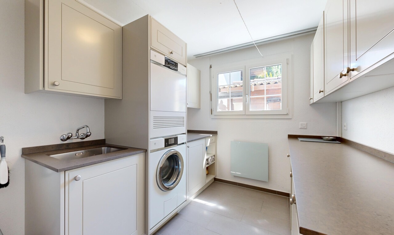laundry area with cabinet space and baseboards