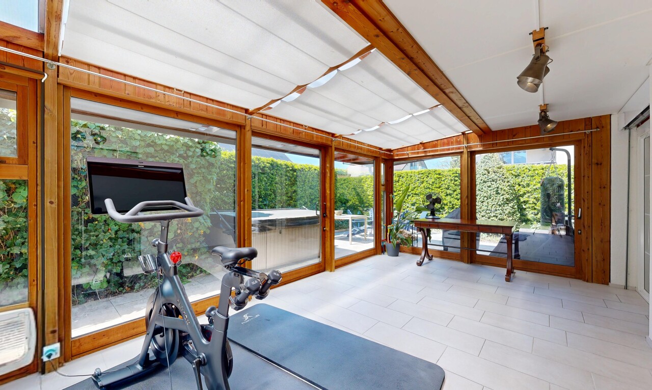 exercise room featuring beamed ceiling