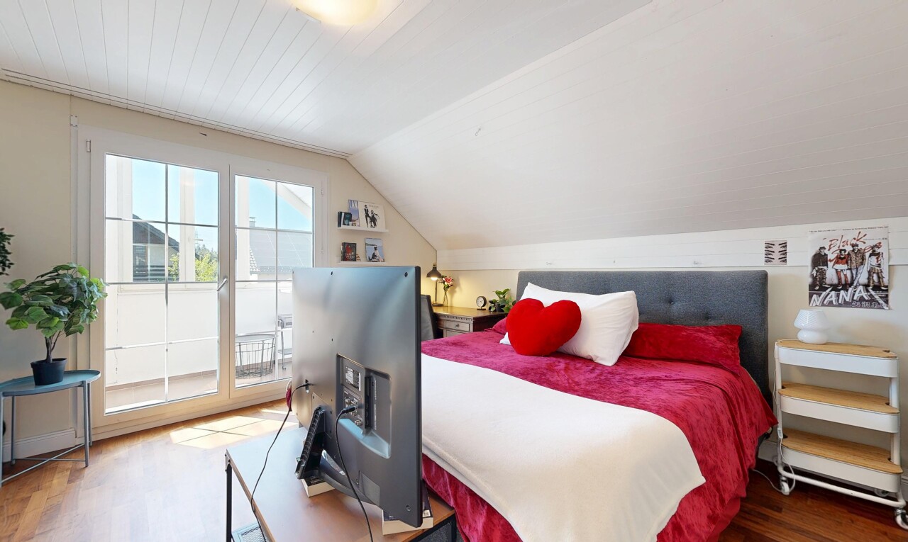 room with wood finished floors and lofted ceiling