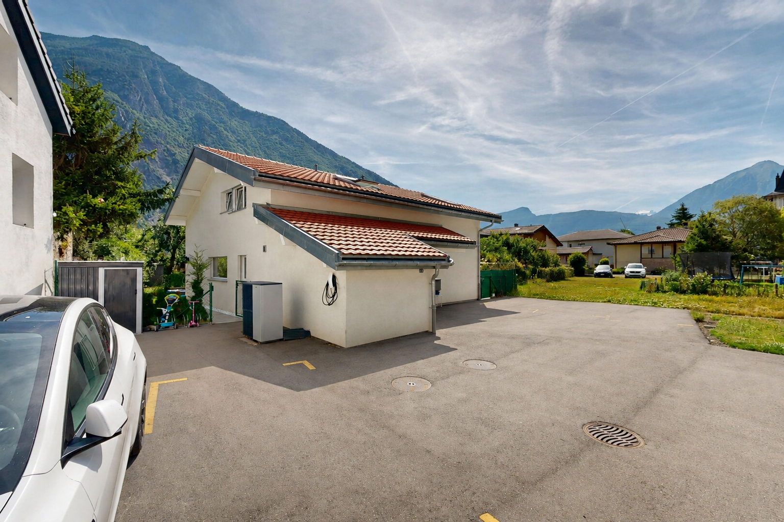 outdoor house with a tiled roof, a mountain view, and stucco siding