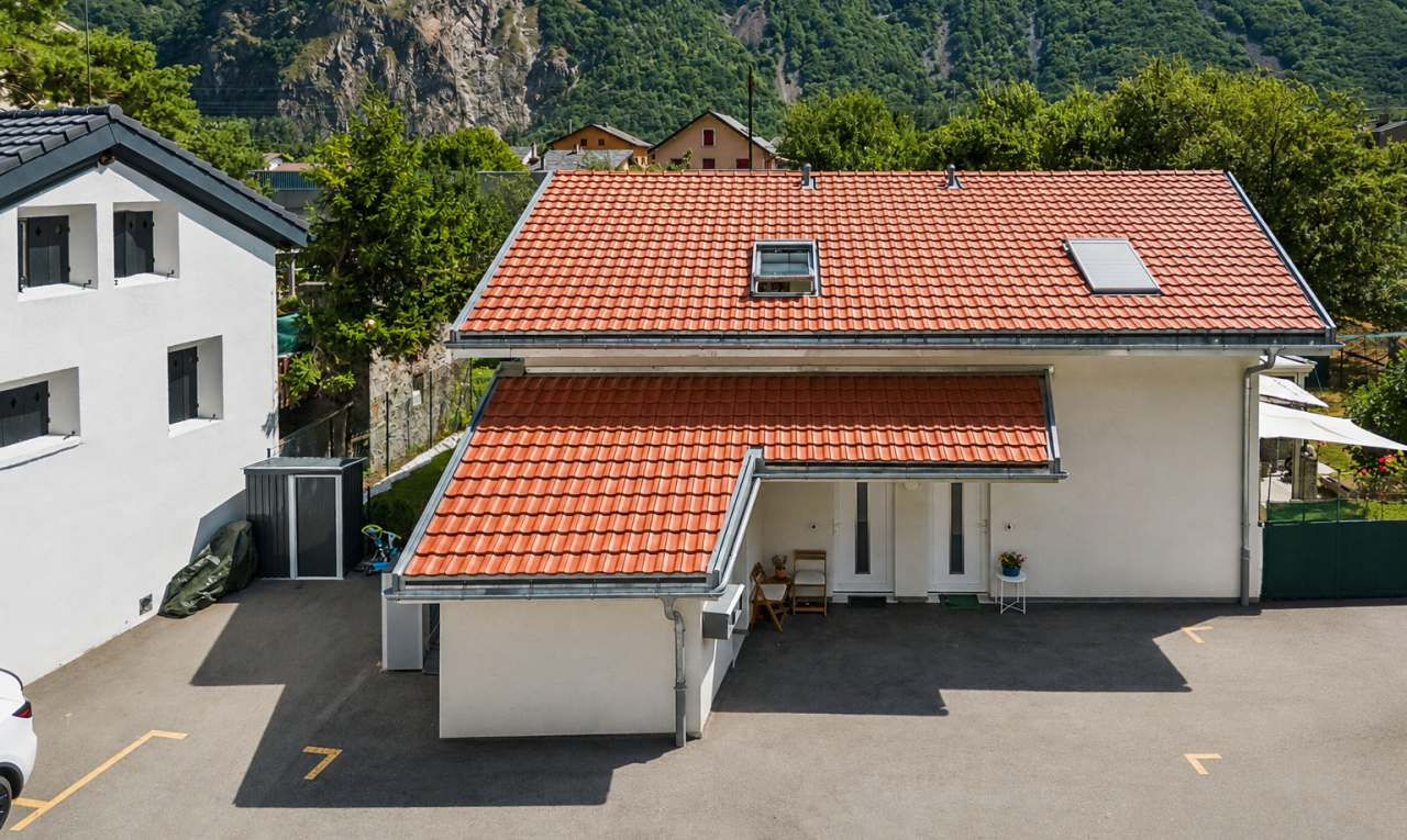 view of property featuring a tile roof, a mountain view, and stucco siding