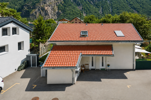 view of property featuring a tile roof, a mountain view, and stucco siding