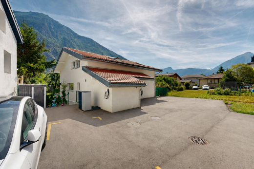 outdoor house with a tiled roof, a mountain view, and stucco siding
