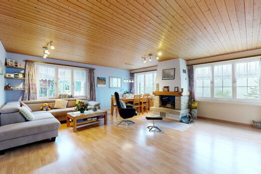 living area featuring wood ceiling, wood finished floors, and a fireplace