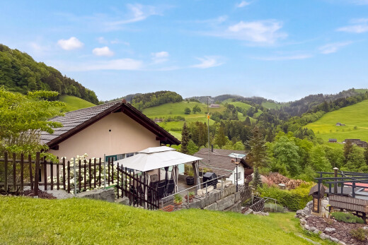 view of home with a gazebo and stucco siding