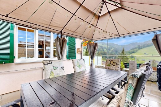 terrace with outdoor dining space and a mountain view