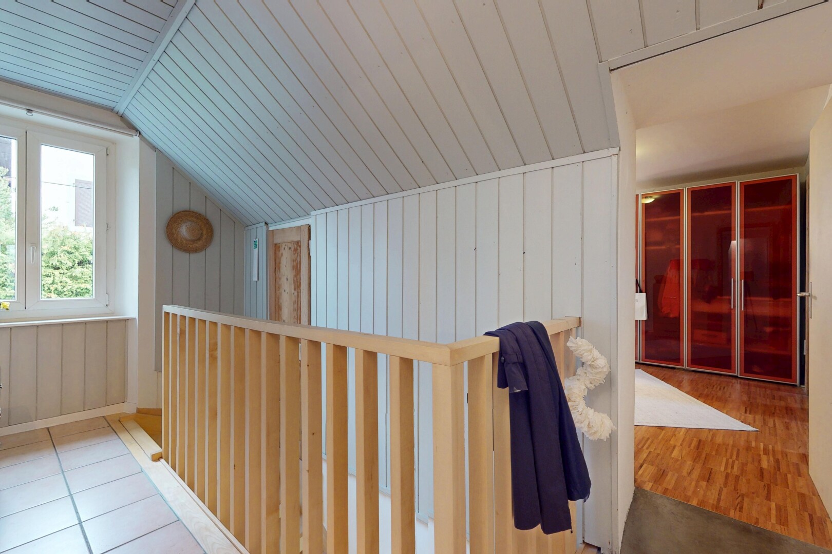 corridor featuring vaulted ceiling, wood ceiling, and wood walls