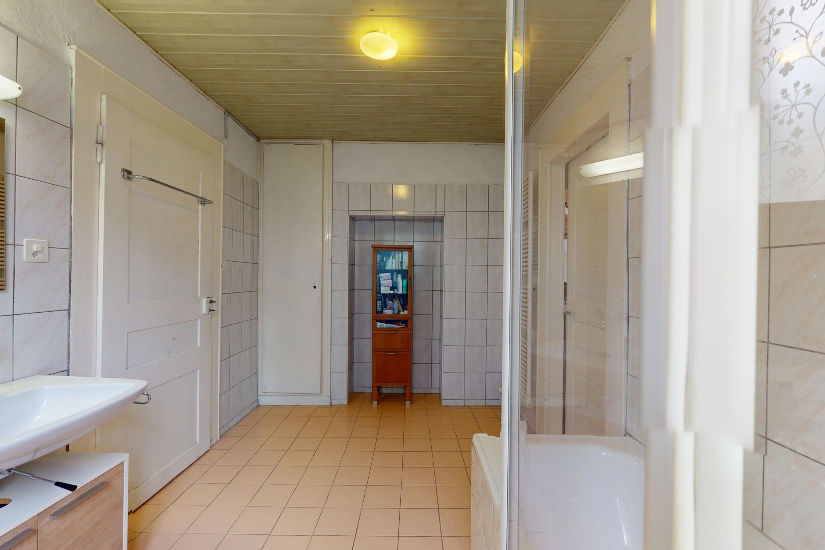full bathroom with tile walls and tile patterned floors