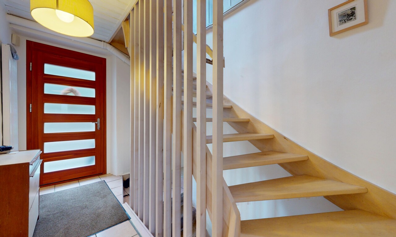 stairway with tile patterned floors