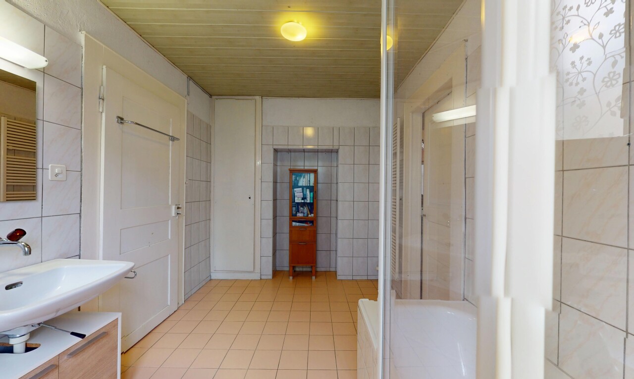 full bathroom with tile walls and tile patterned floors