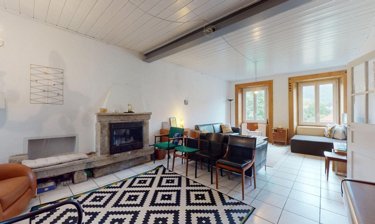 living room featuring a glass covered fireplace, a wood ceiling with exposed beams, and light tile patterned flooring