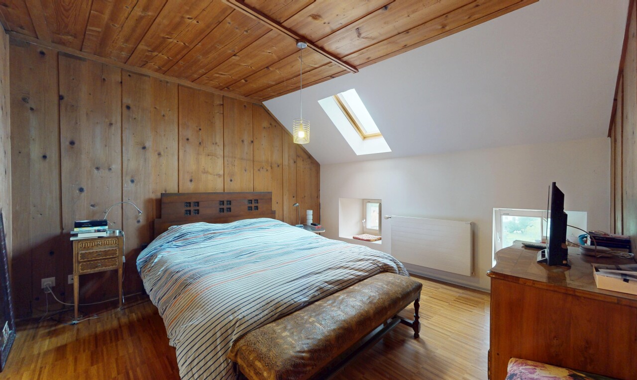 room / bedroom featuring a skylight, vaulted ceiling, wood finished floors, wooden walls, and wood ceiling