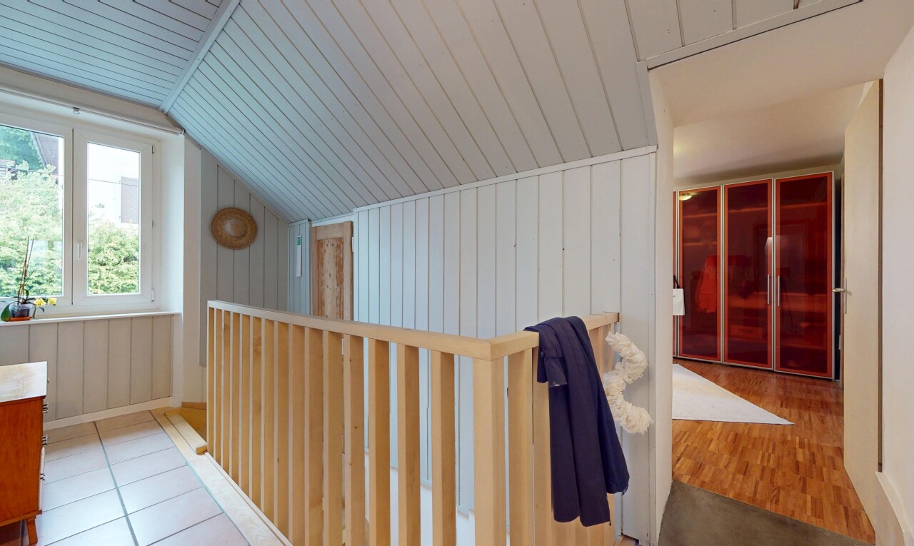 corridor featuring vaulted ceiling, wood ceiling, and wood walls