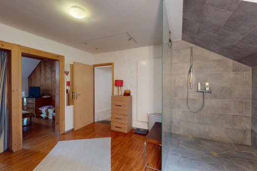 salle de bains avec vaulted ceiling, plafond voûté, douche, inside property, et wood finish floor