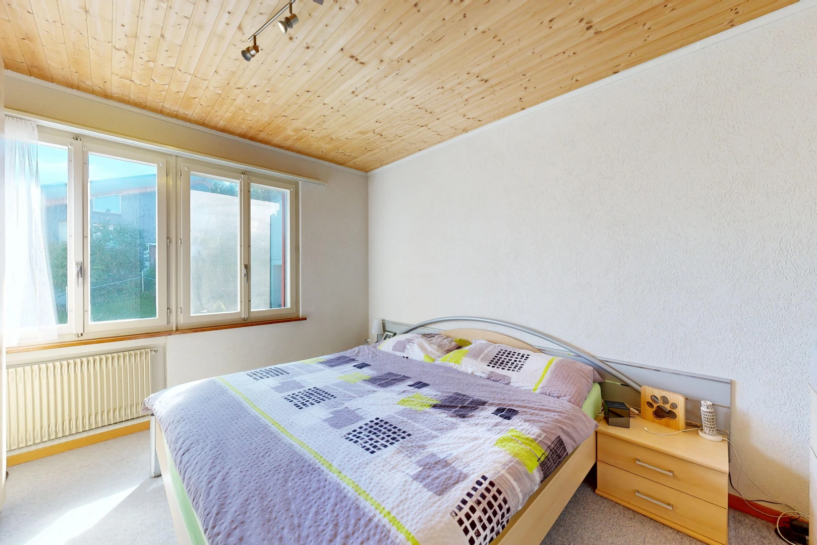 room with wood ceiling, radiator, light colored carpet, and rail lighting