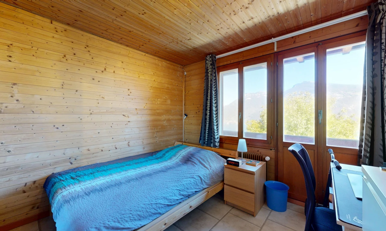 room / bedroom with wooden ceiling, a desk, wooden walls, a mountain view, and light tile patterned floors