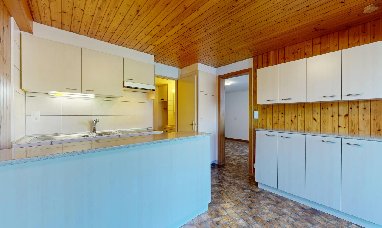 kitchen featuring light countertops, wooden ceiling, backsplash, and wood walls