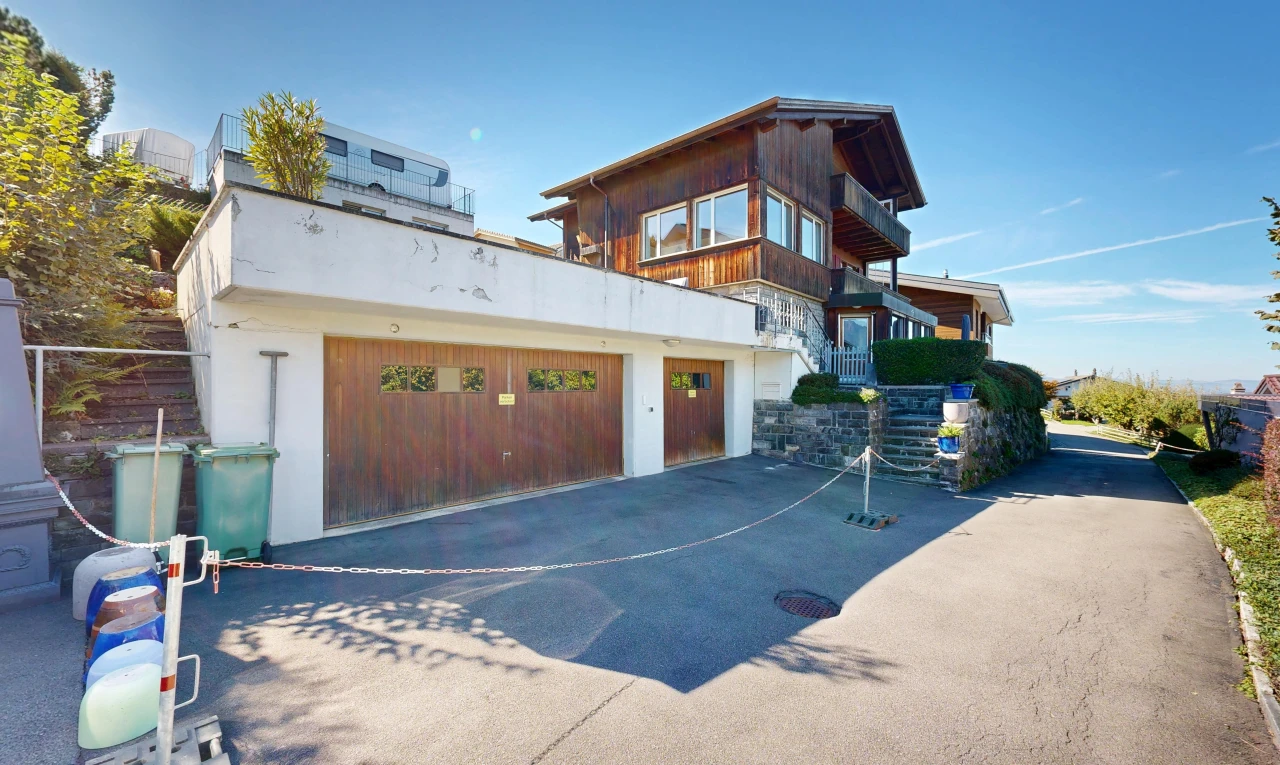 view of property with a garage and driveway