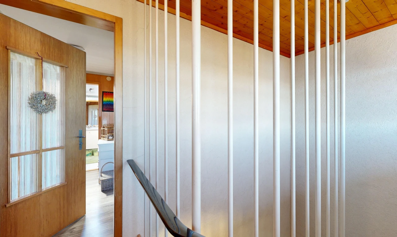 stairway with wooden ceiling